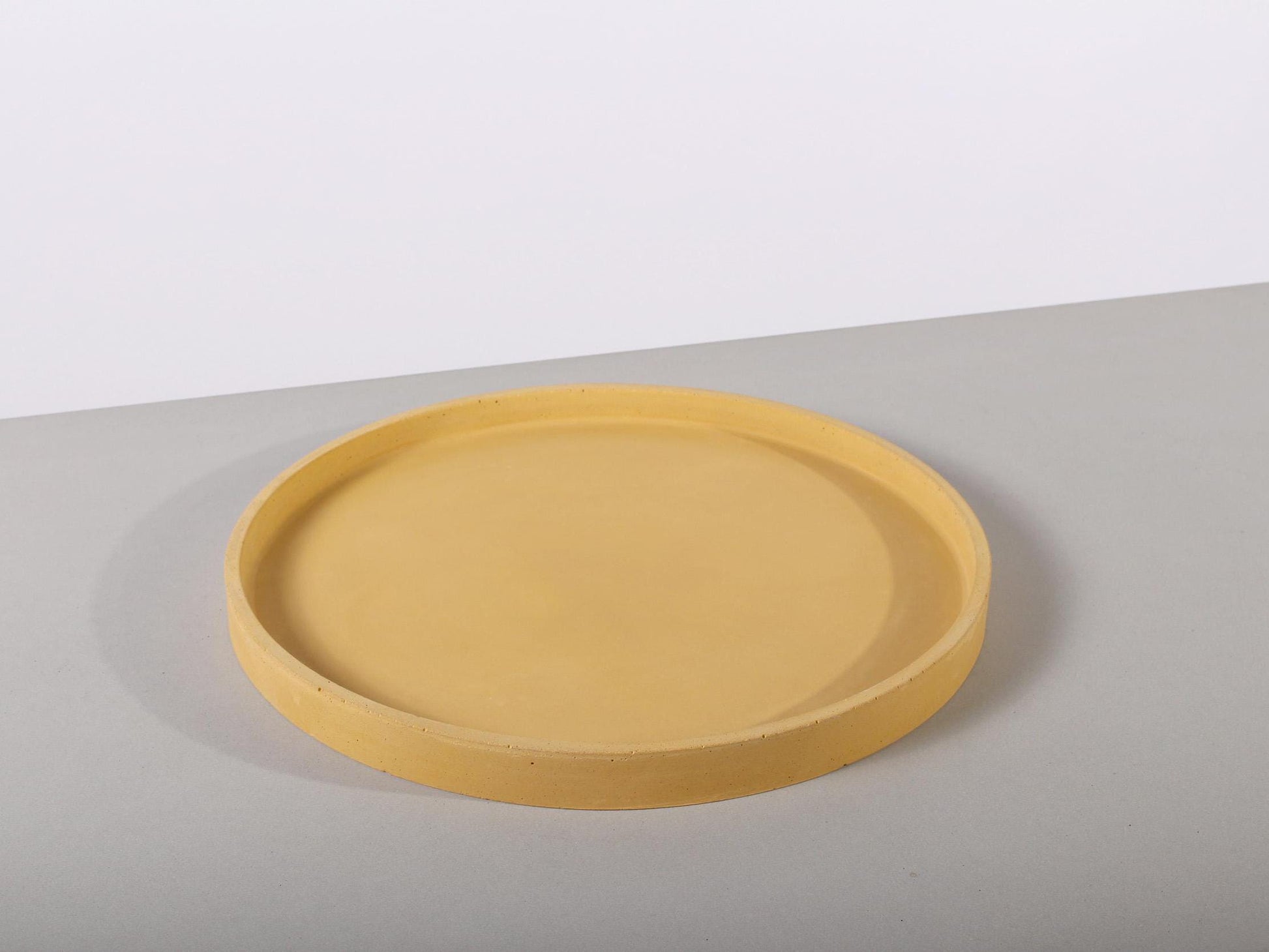 yellow ottoman concrete tray round