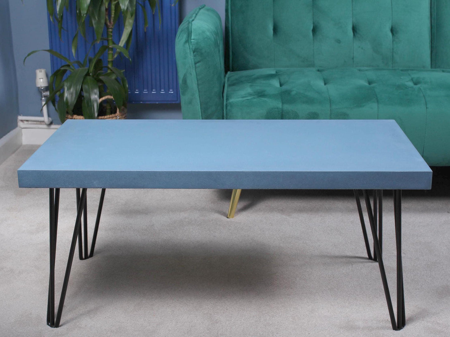 Large blue concrete coffee table with hairpin legs