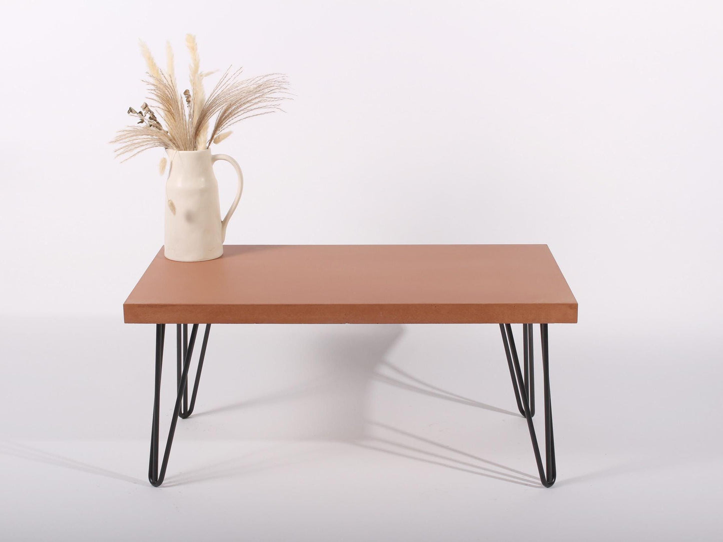 Large terracotta coffee table with hairpin legs