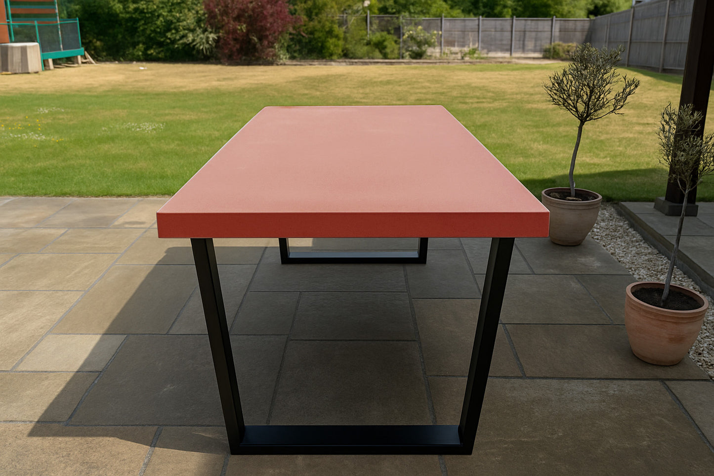 Red outdoor table with black legs on a patio