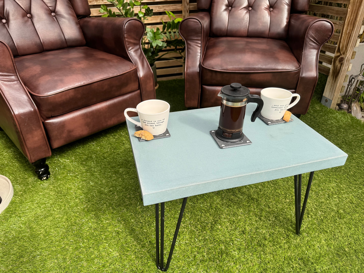 grey outdoor concrete table with coffee on top