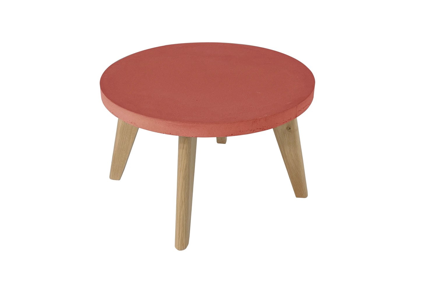 Round red table with wooden legs on a white background