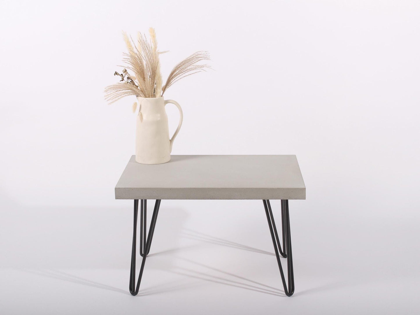 small grey concrete table with hairpin legs