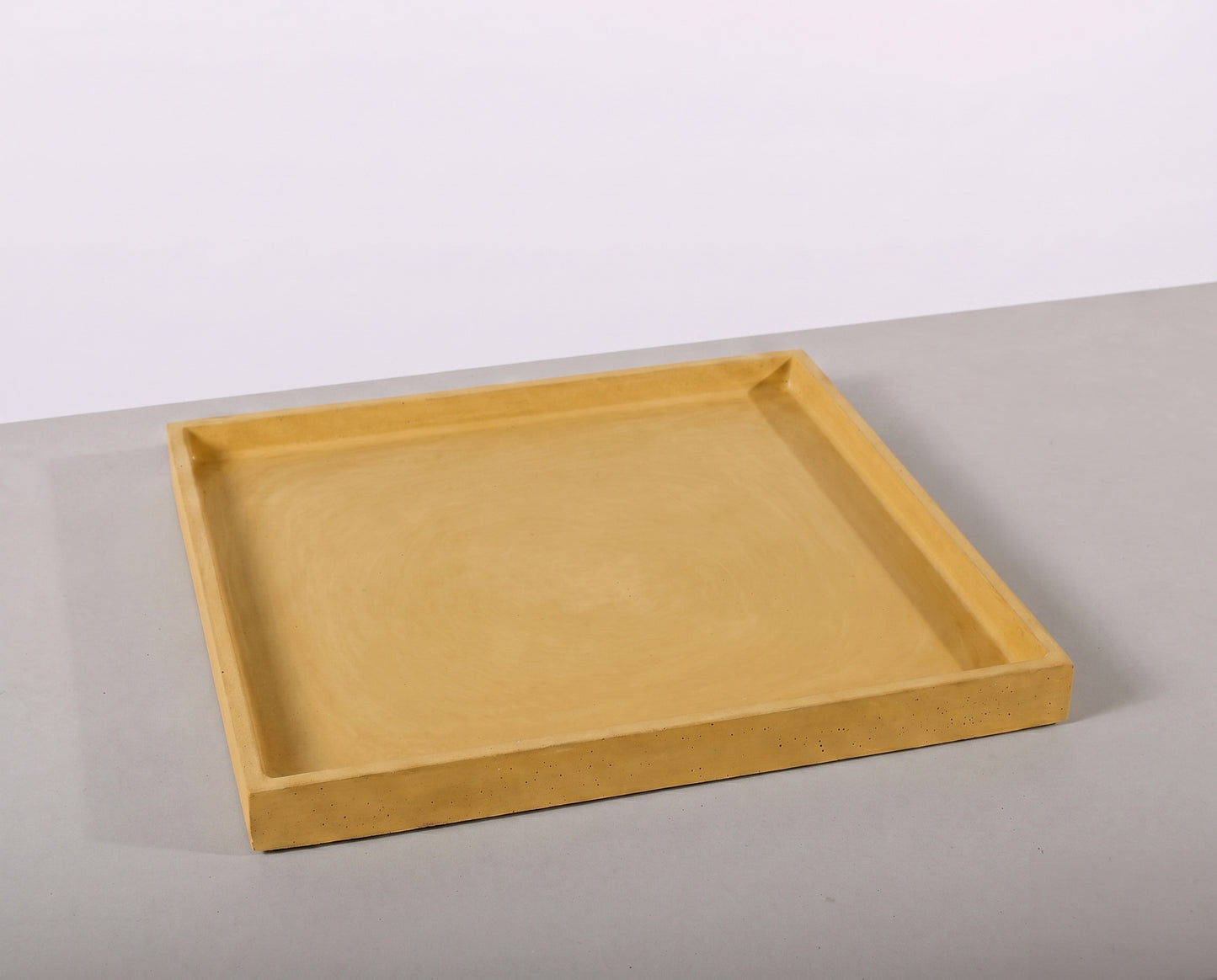 Beige tray on a light gray surface with a white background