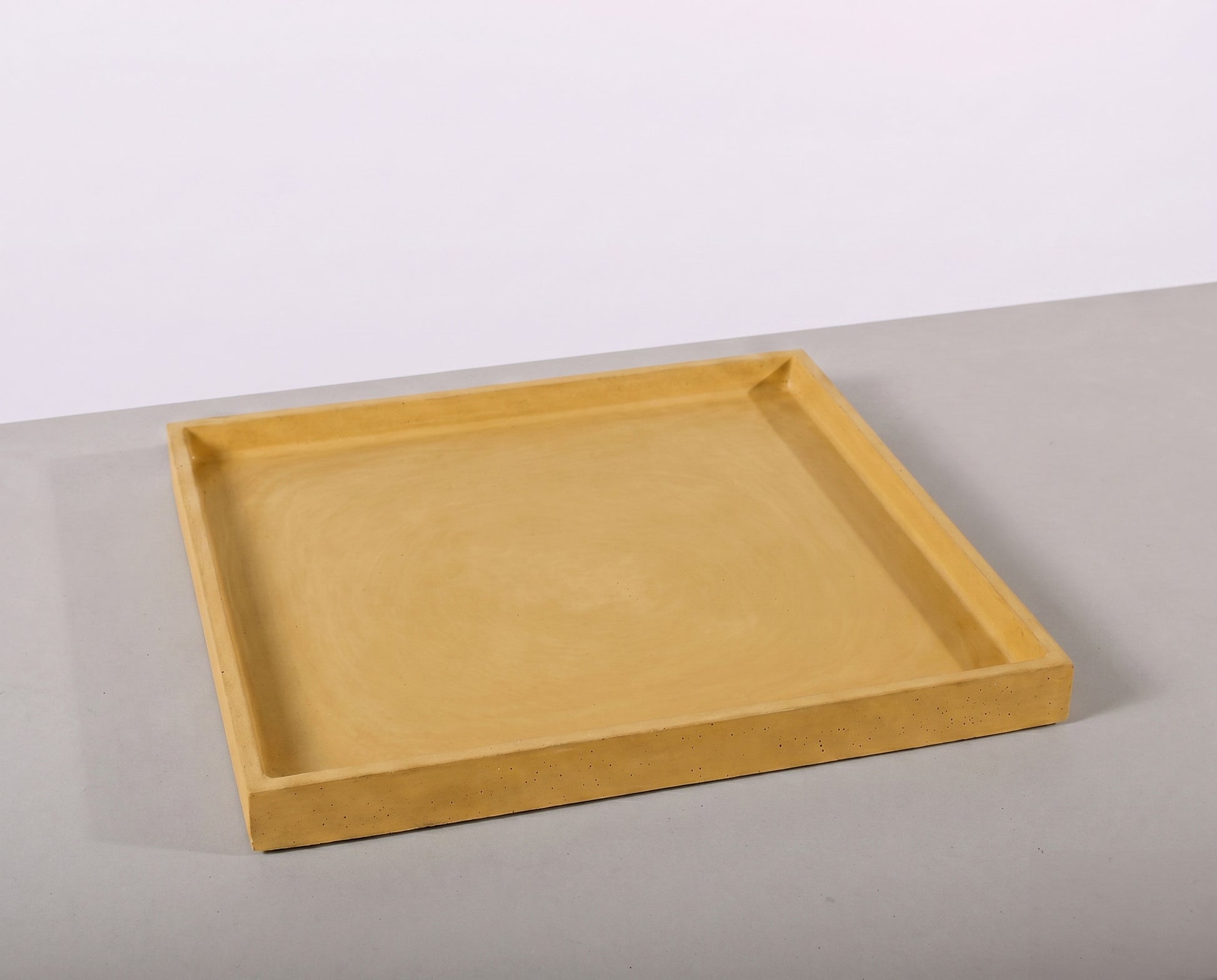 Beige tray on a light gray surface with a white background
