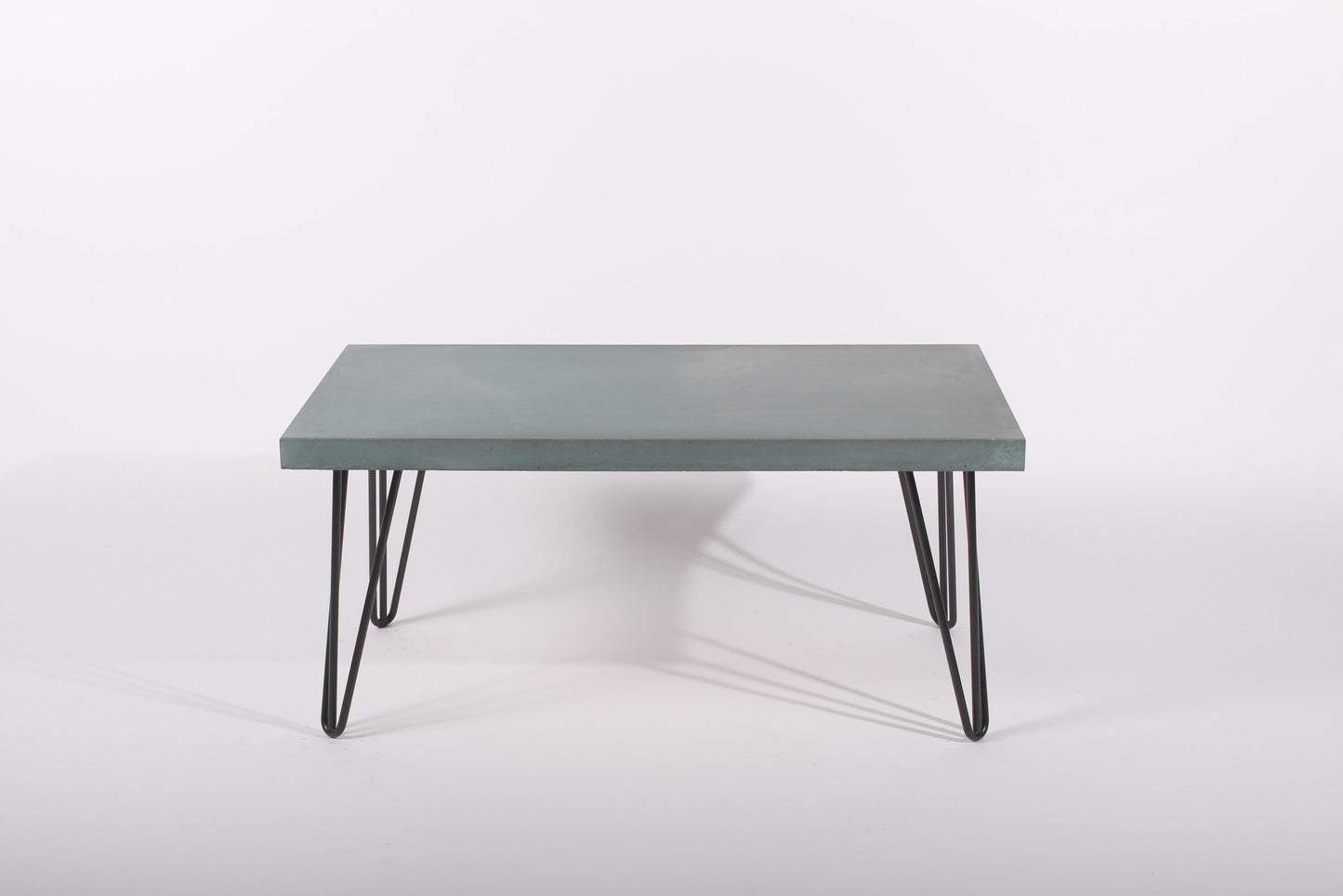 Lagoon blue coffee table with black metal legs on a white background