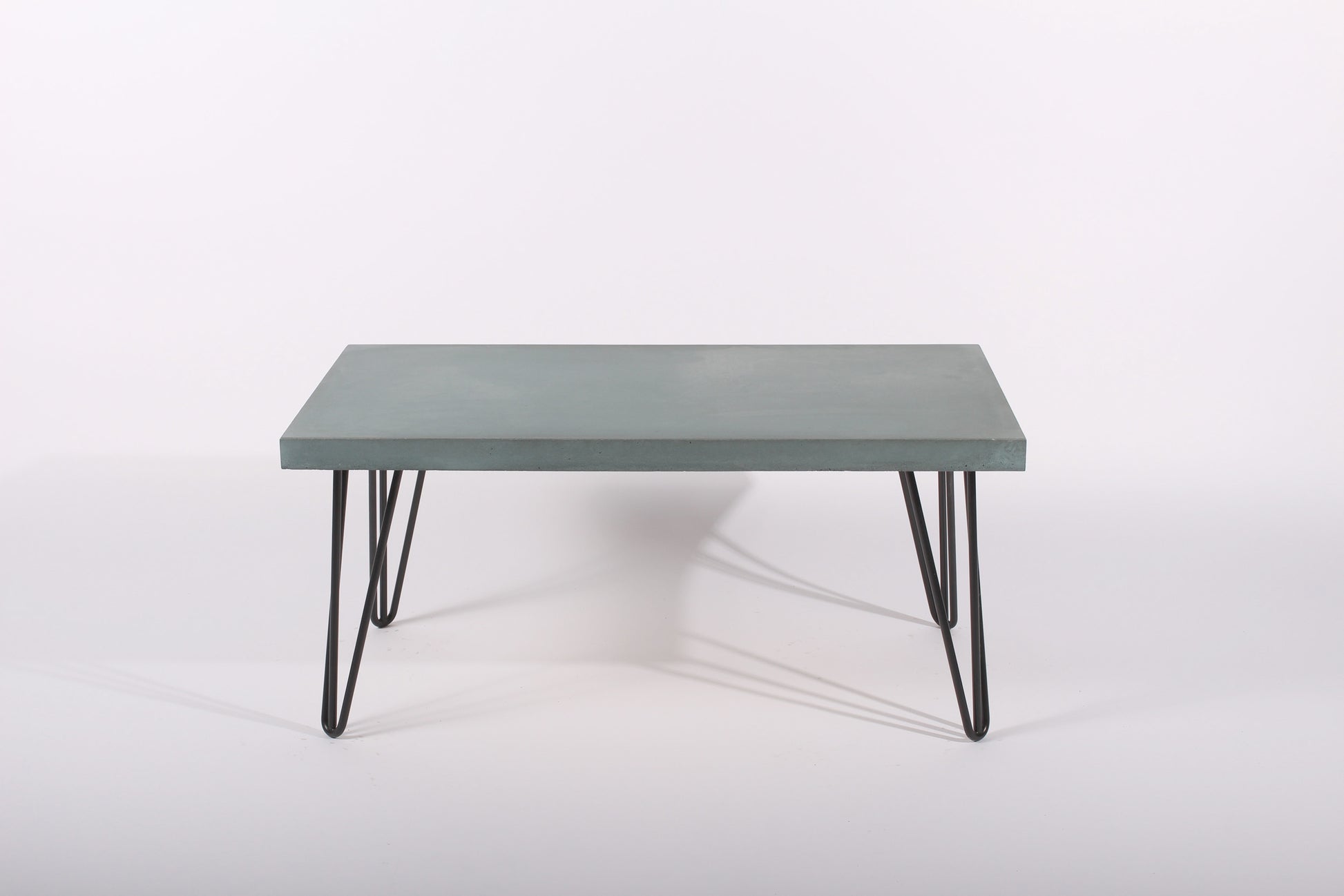 Lagoon blue coffee table with black metal legs on a white background