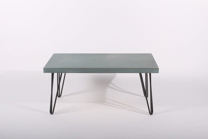 Lagoon blue coffee table with black metal legs on a white background