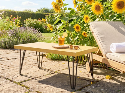 Outdoor setting with a garden table, sunflower garden, and lounge chair.