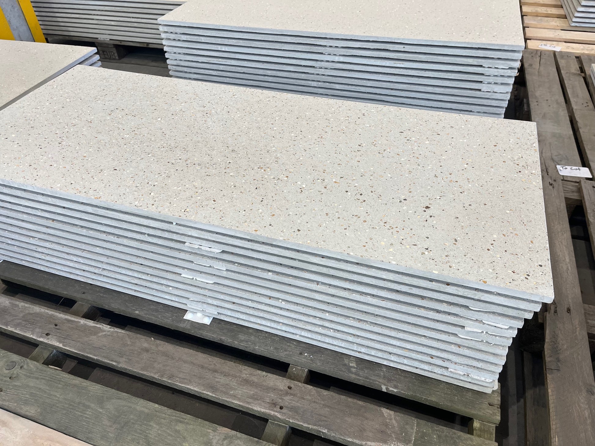 Stacks of concrete tiles on a wooden pallet