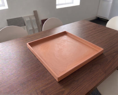 concrete tray on a wooden table with a neutral background