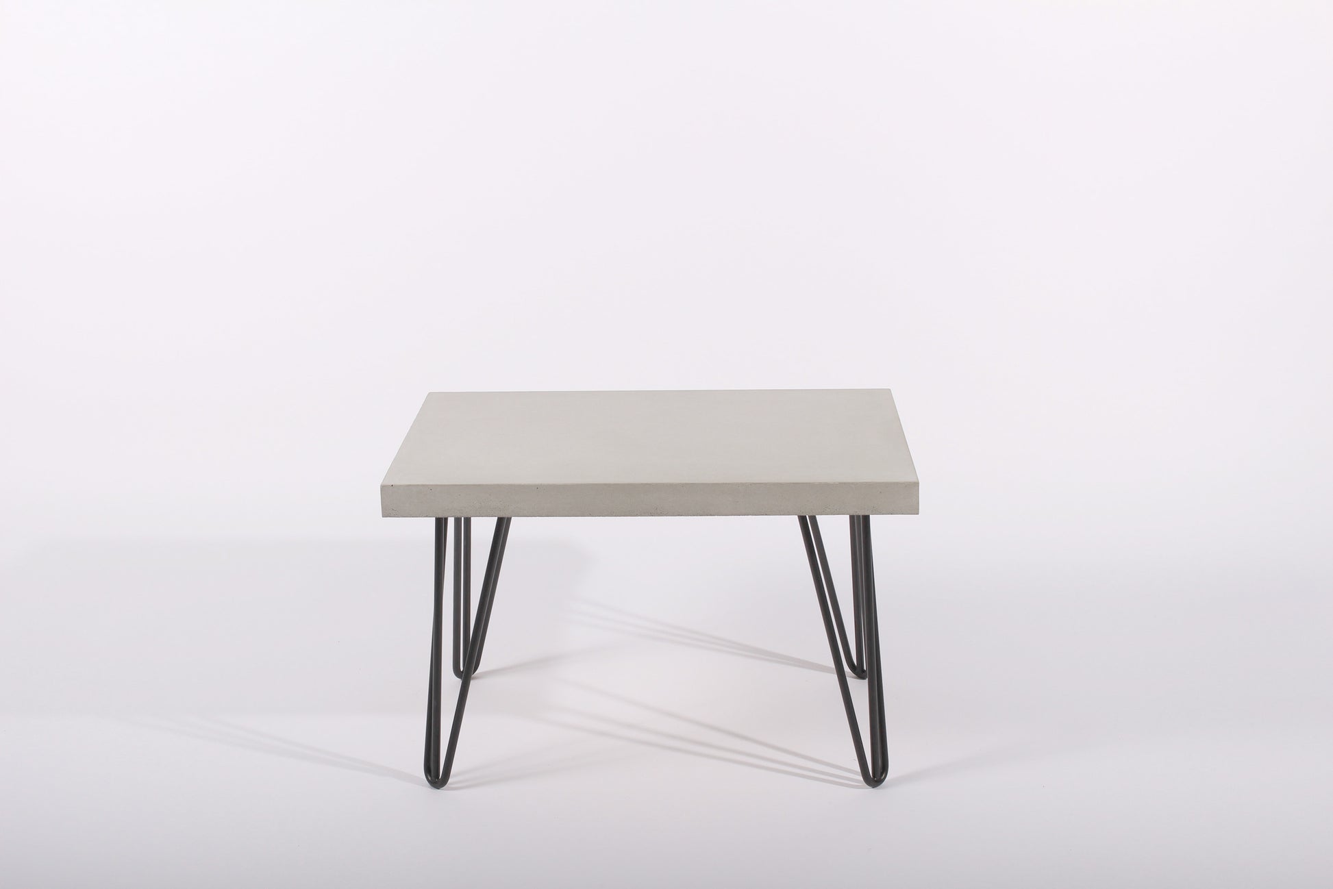 rectangular table with a light gray top and black metal legs on a white background