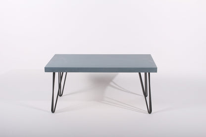 Lagoon blue table with black hairpin legs on a white background