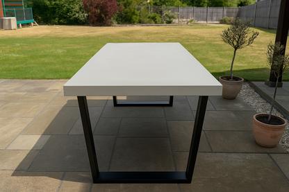 Portland Grey outdoor dining table with black legs on a patio