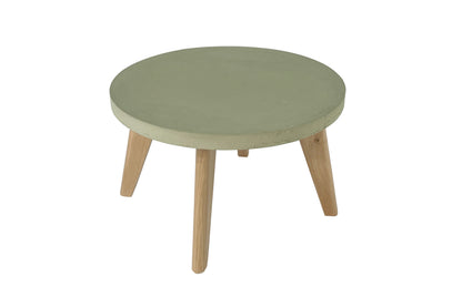 Round green table with wooden legs on a white background
