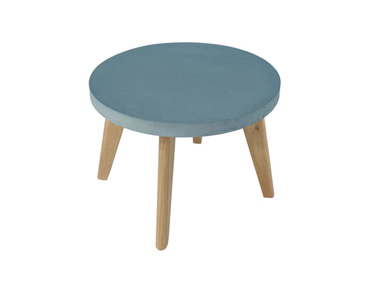 Round coffee table with blue top and wooden legs on a white background