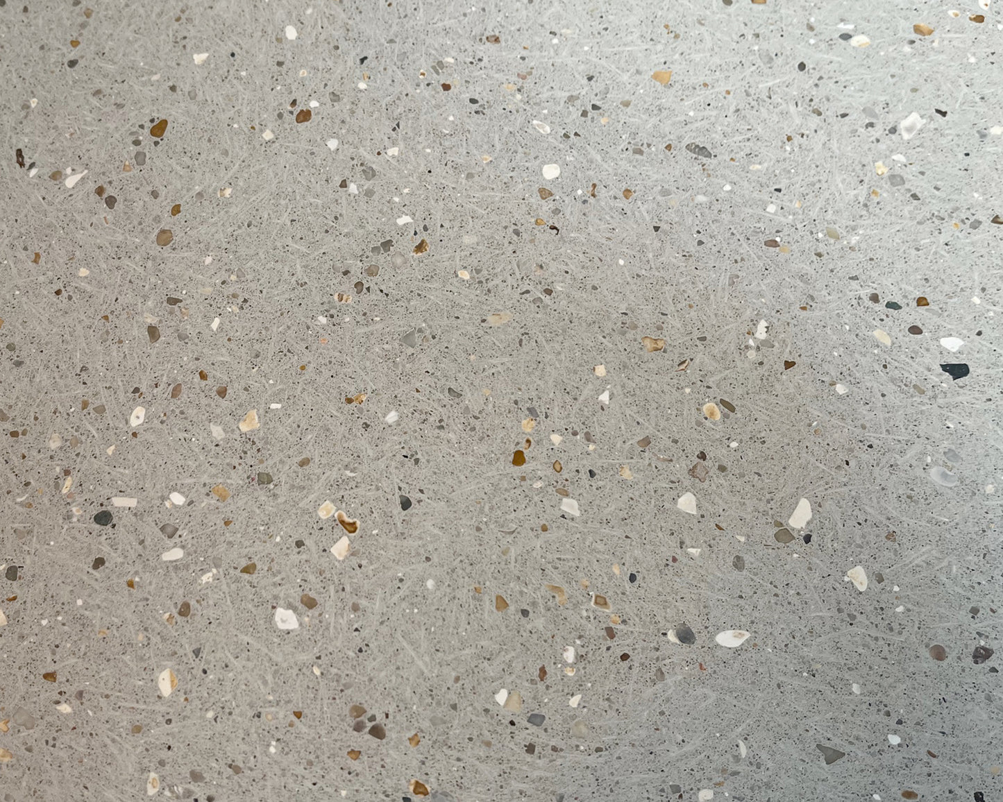 Close-up of a concrete tile with small stones and chips
