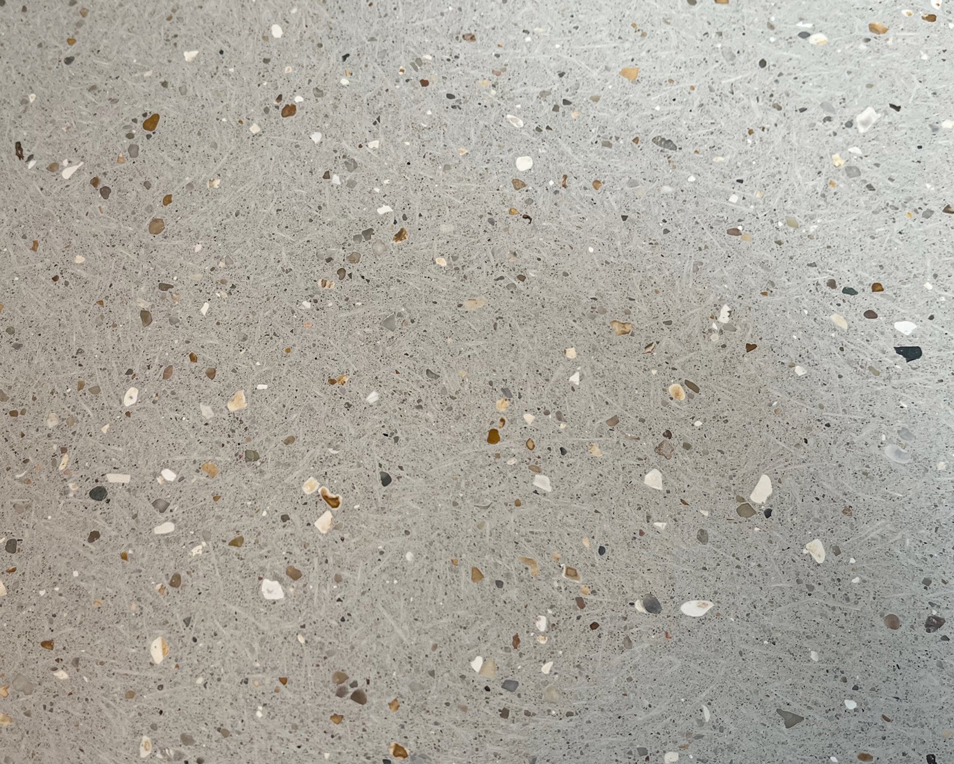 Close-up of a concrete tile with small stones and chips