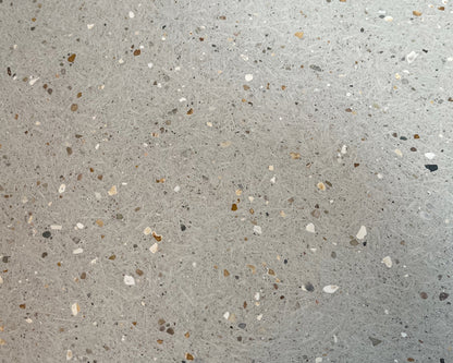 Close-up of a concrete tile with small stones and chips