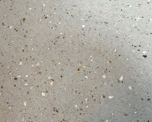 Close-up of a concrete tile with small stones and chips