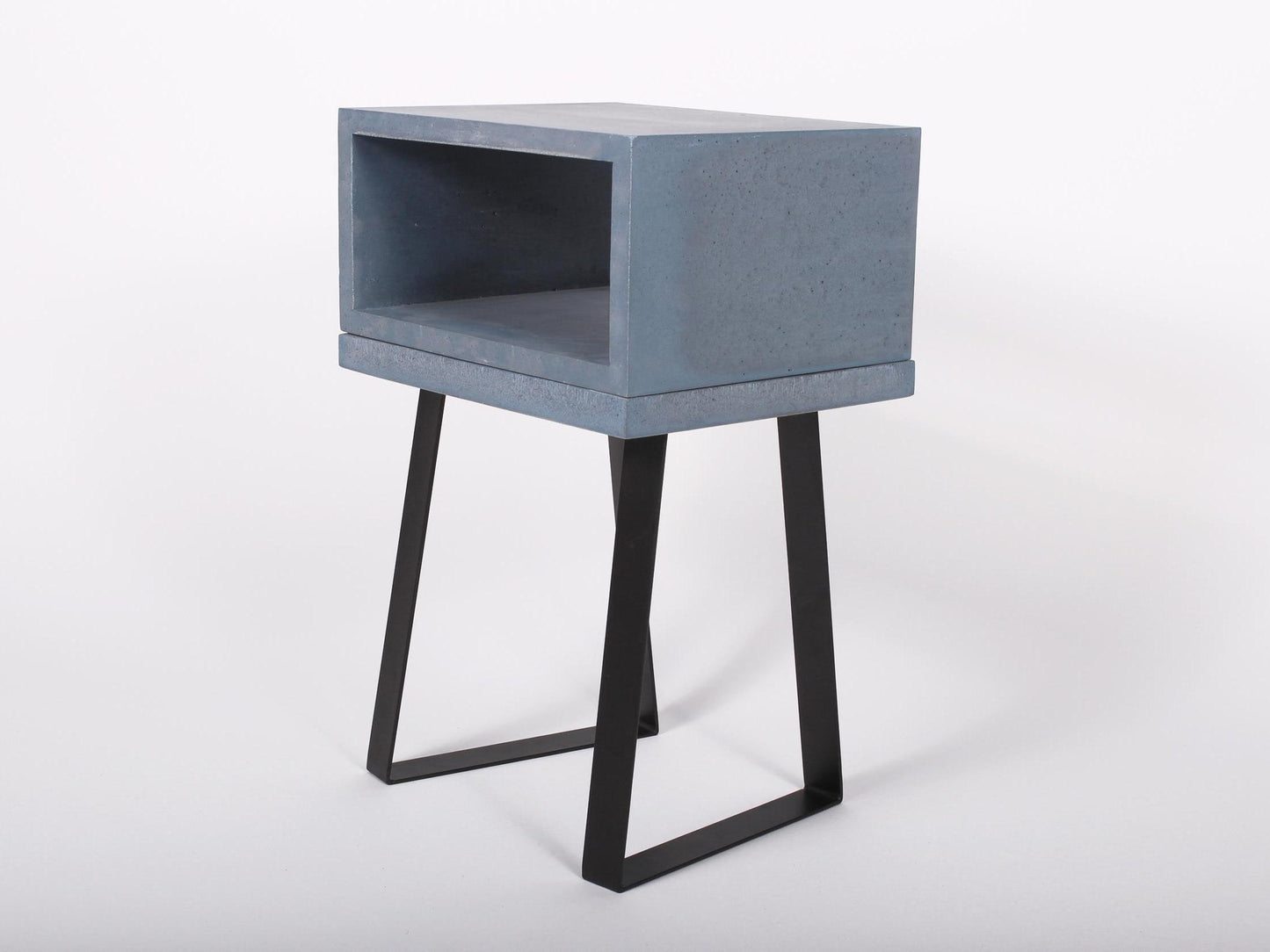 Blue concrete bedside table with trapezium legs 
