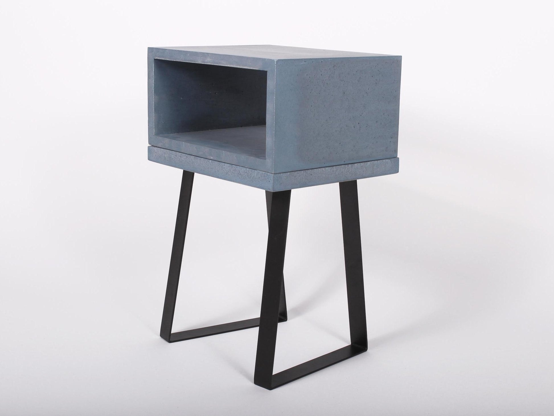 Blue concrete bedside table with trapezium legs 