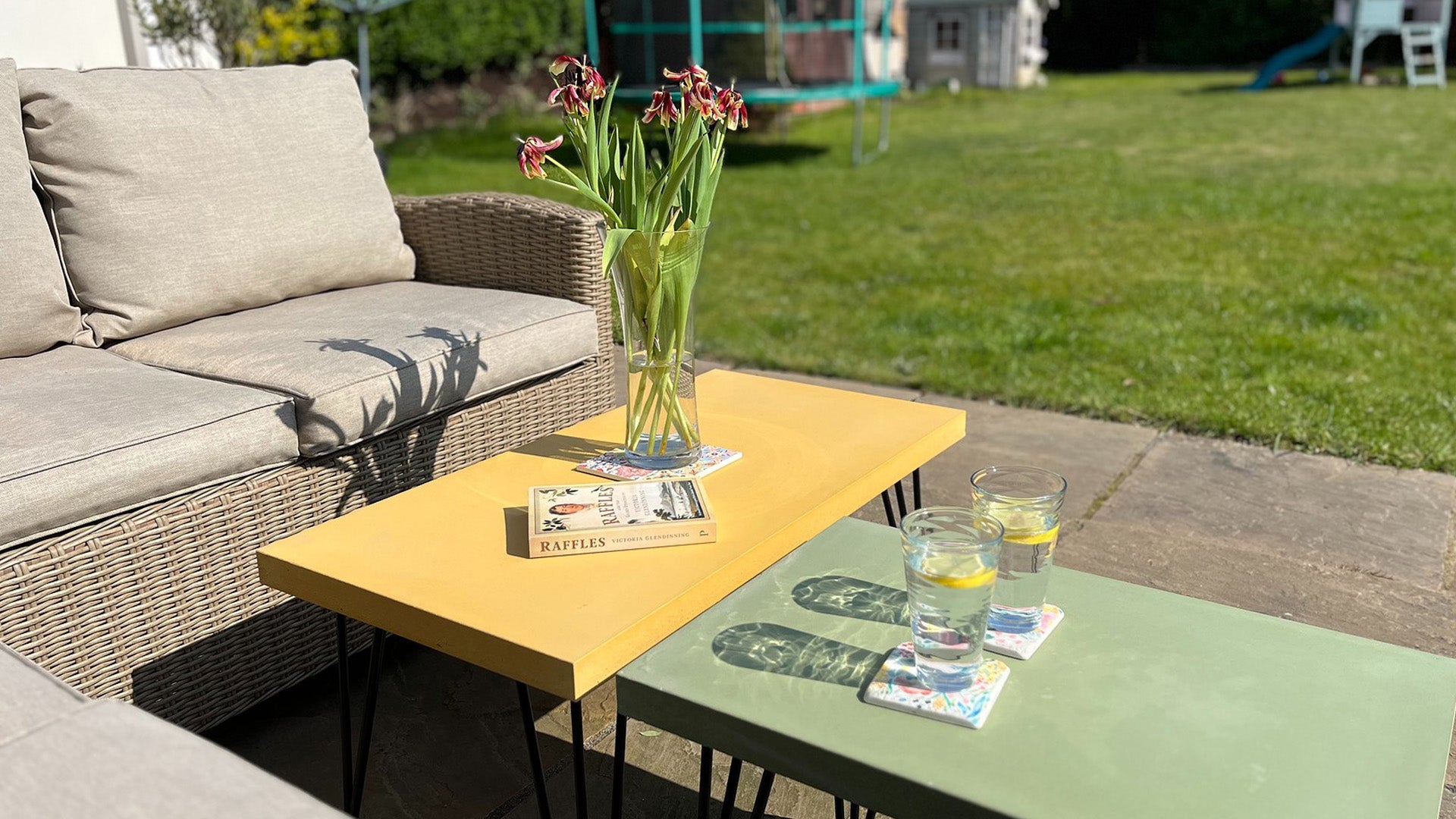 yellow and green concrete tables outside in the garden