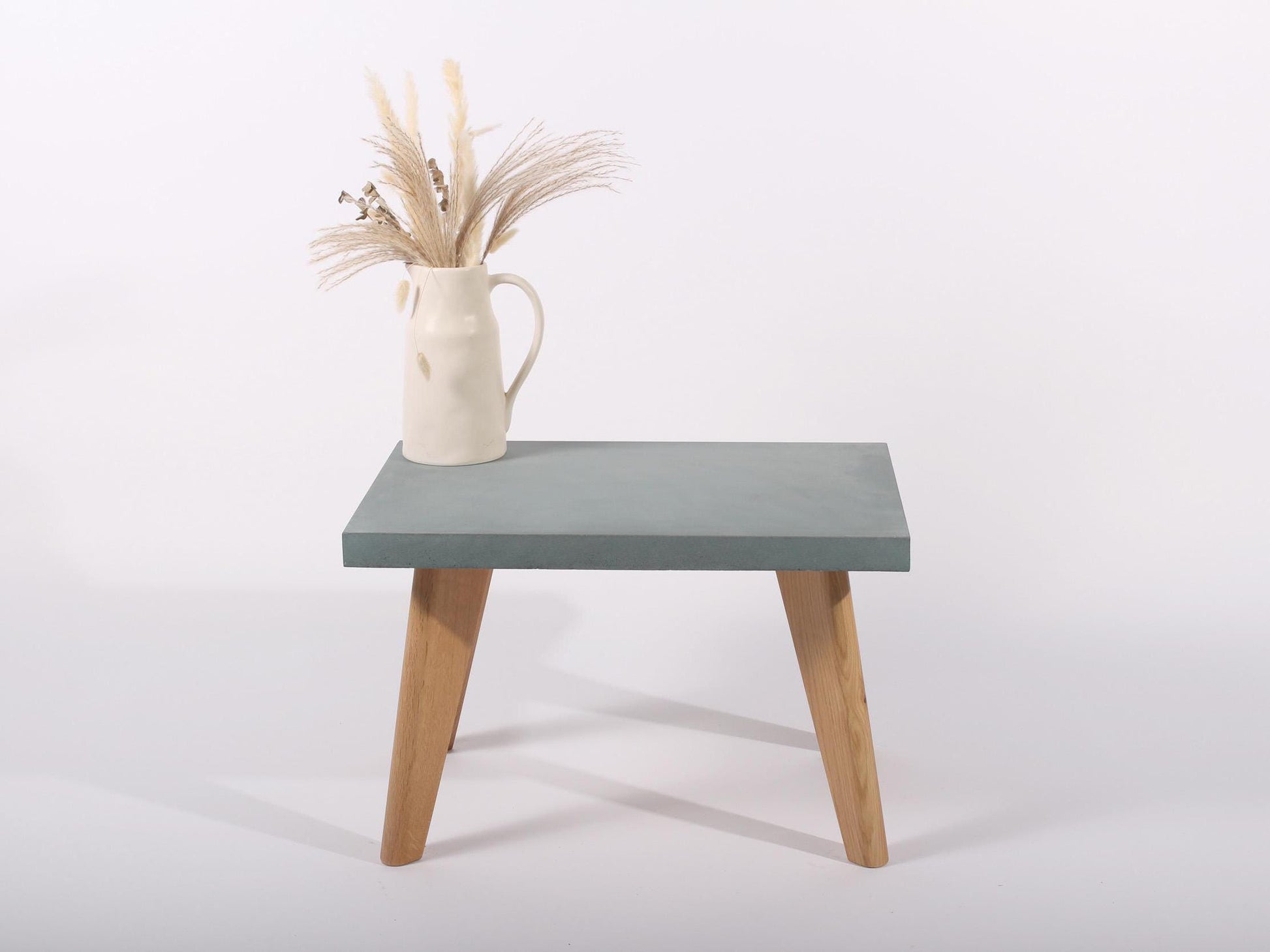 small lagoon blue concrete table with oak legs