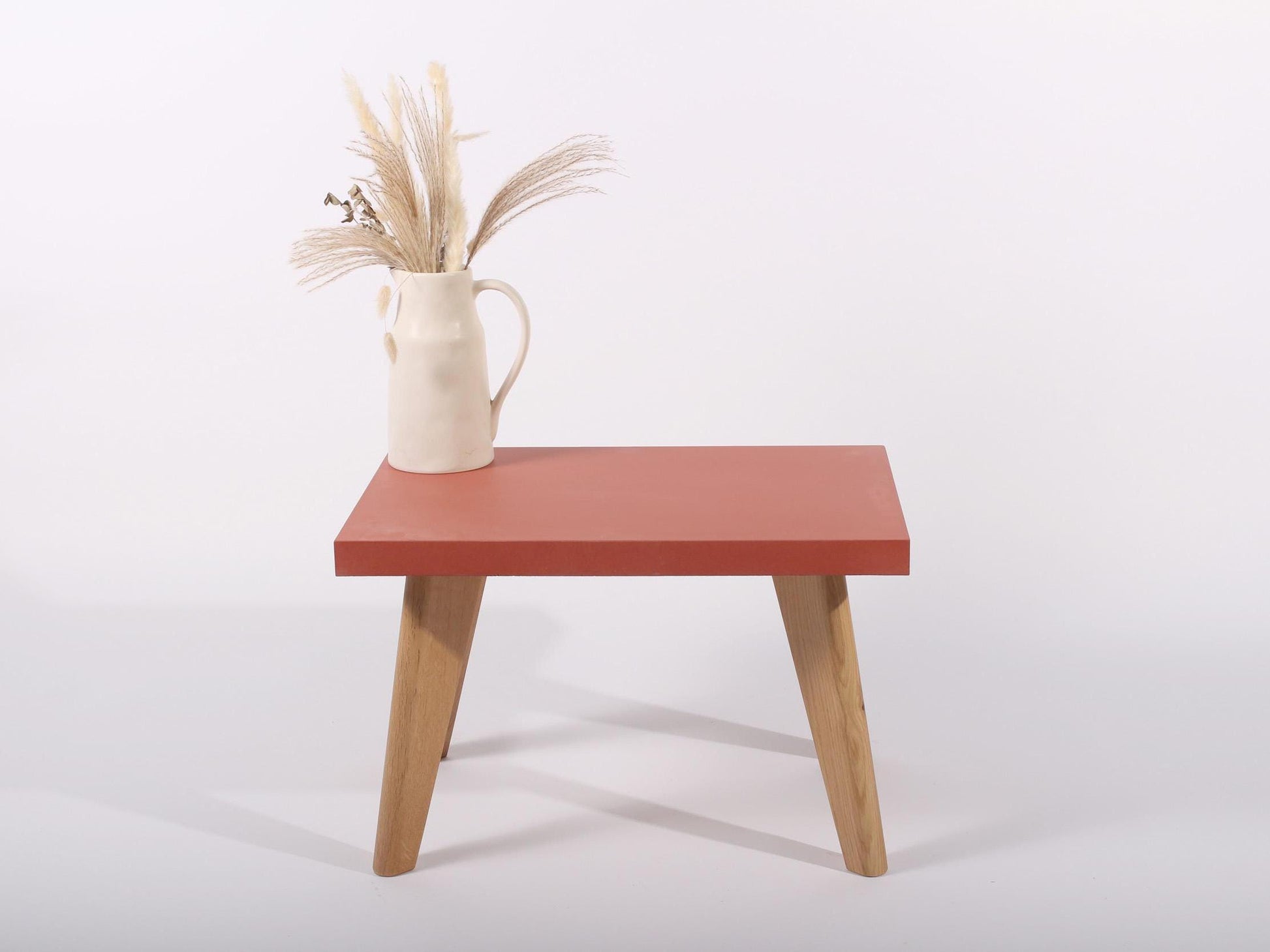 small red concrete table with oak legs