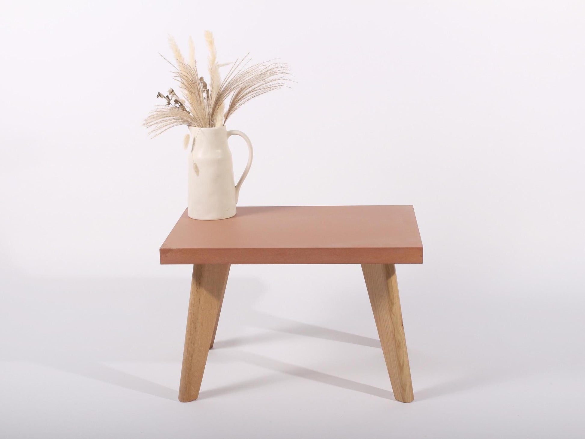 small terracotta concrete table with oak legs