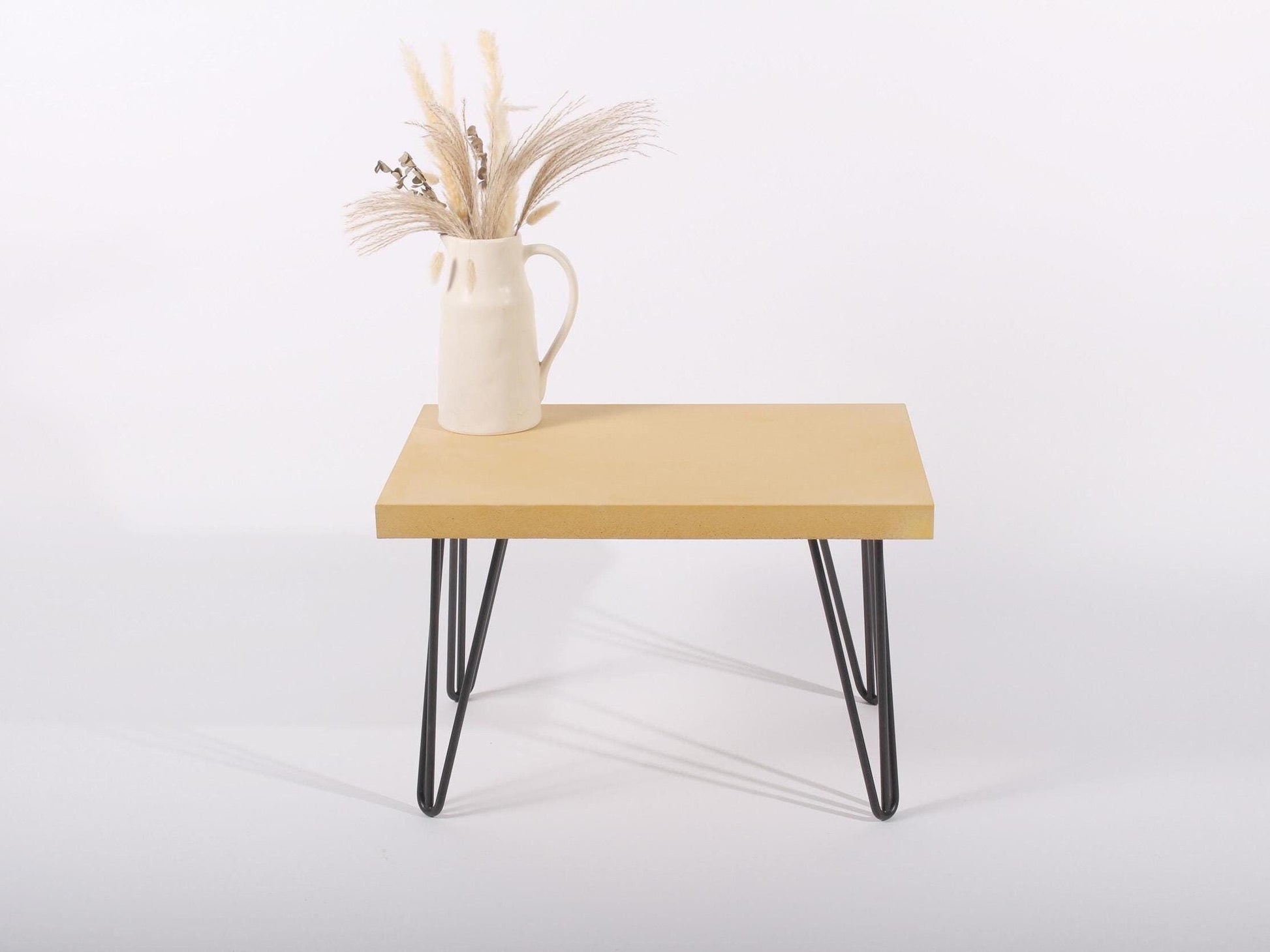 small yellow concrete table with hairpin legs