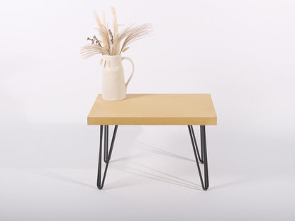 small yellow concrete table with hairpin legs